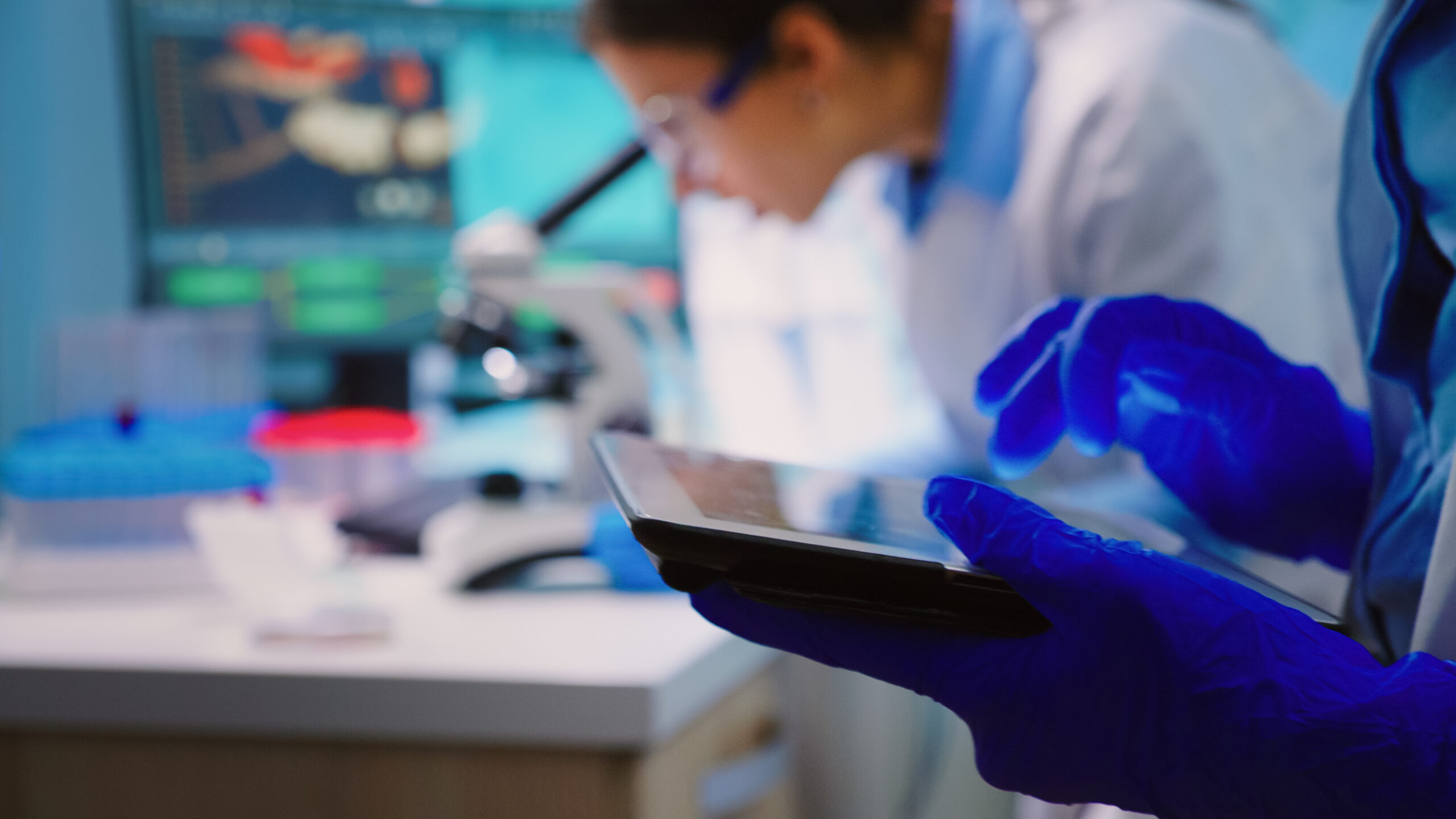 Close up of scientist writing on tablet